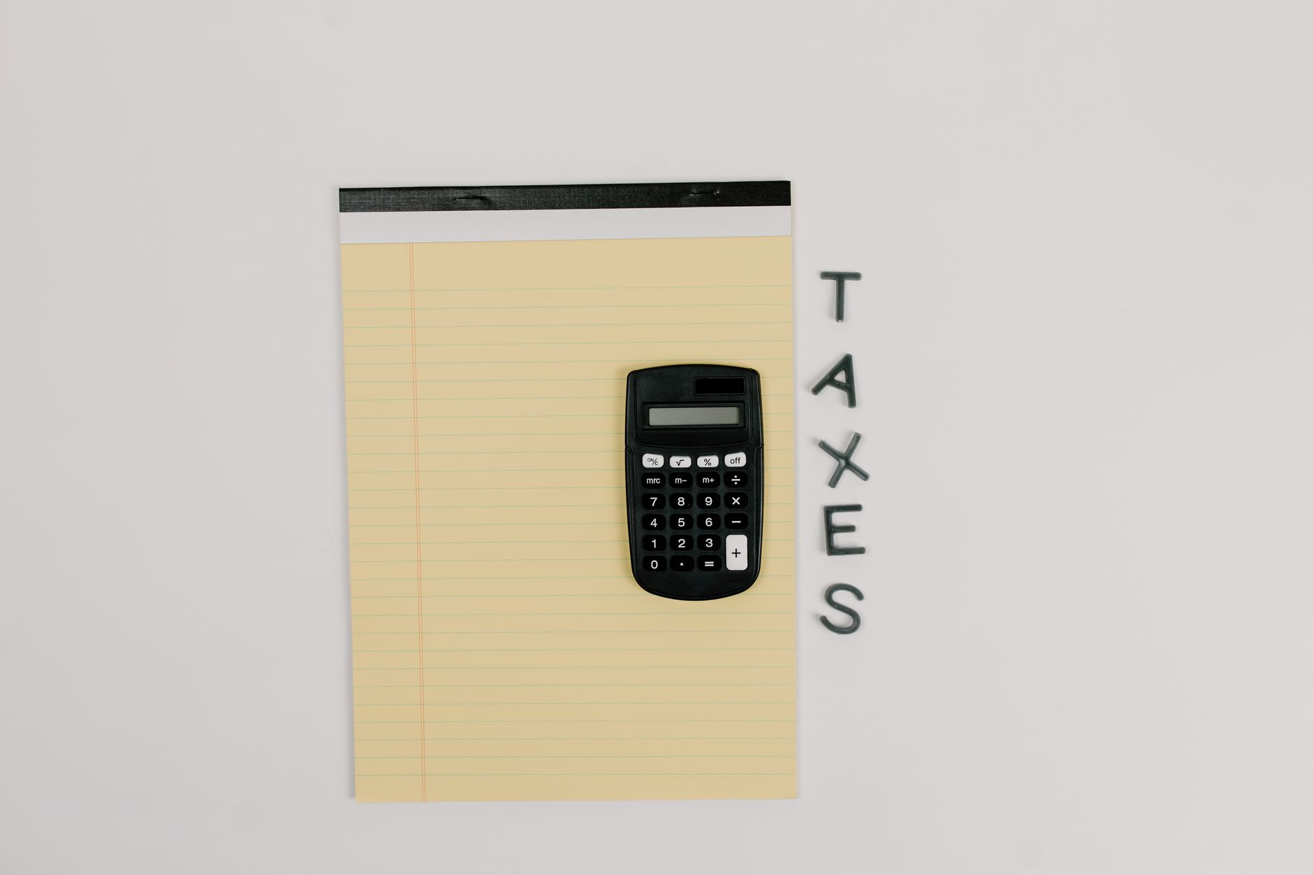 Desk with tax ledger forms and calculator