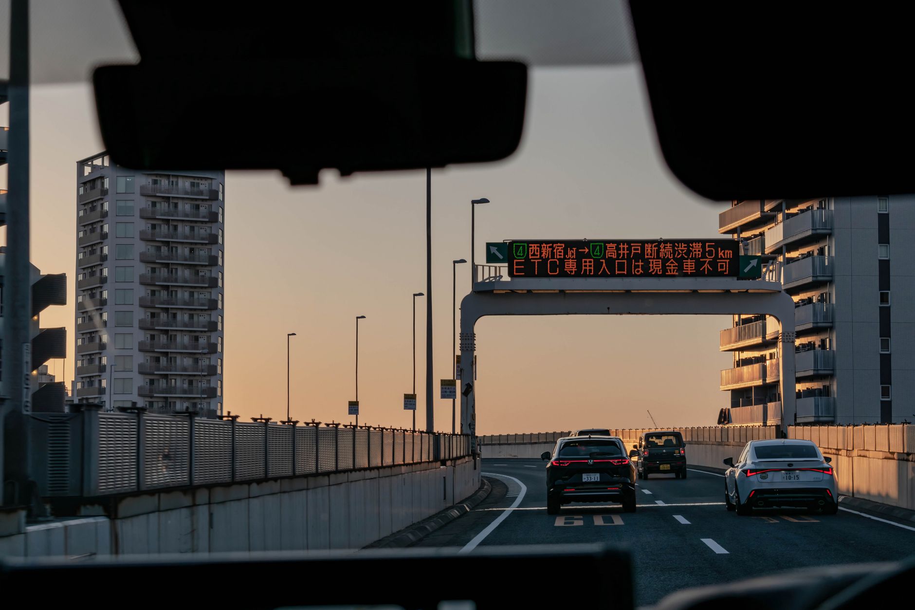 Tokyo highway with skyscrapers in sunset representing trade routes