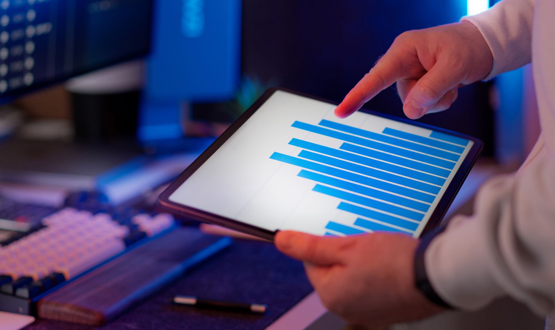 Tokyo office desk with tablet displaying financial chart